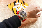 Casio G-Shock watch on wrist, red strap and gold-tone bezel with black chronograph dial