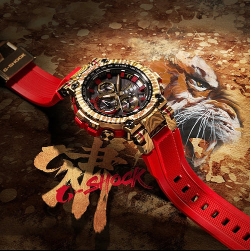 Casio G-Shock watch with red resin strap and gold-tone round bezel, black dial