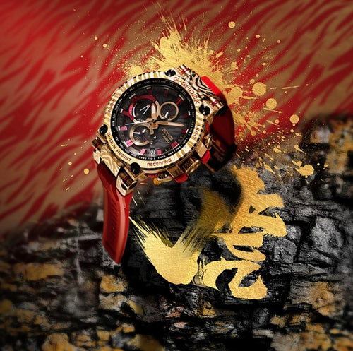Casio G-Shock watch on red strap, gold-tone case with black chronograph dial
