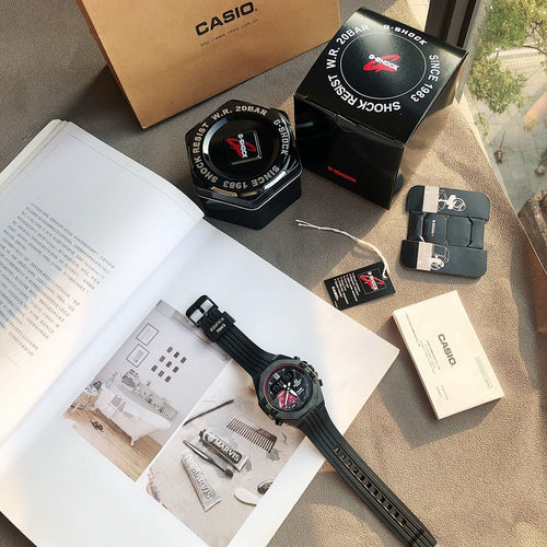Casio Edifice wristwatch with black resin strap and dark dial, shown with boxed accessories