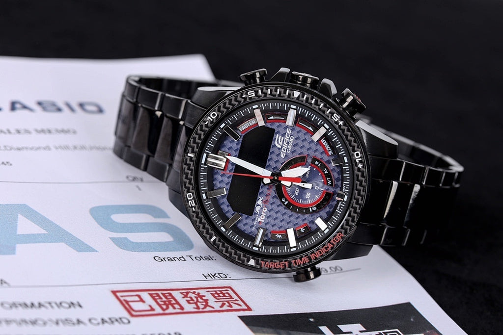 Casio watch on documents with black metal strap, blue dial and red-ring sub-dial