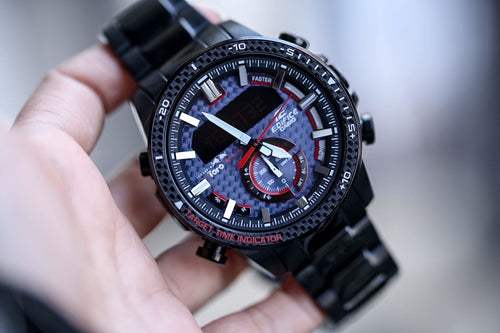 Casio watch with black metal link strap and multi-dial blue face, red accents