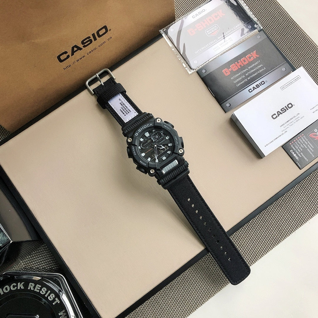Casio watch on black perforated strap, angled view of round black digital face