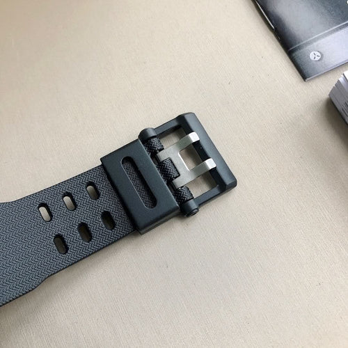 Casio G-Shock watch strap buckle with black resin band and metal clasp