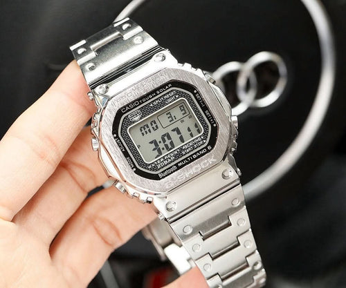 Silver-tone metal digital watch with rectangular LCD display