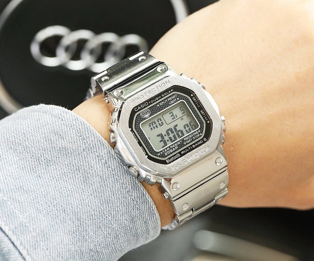 Silver-tone metal digital watch worn on wrist