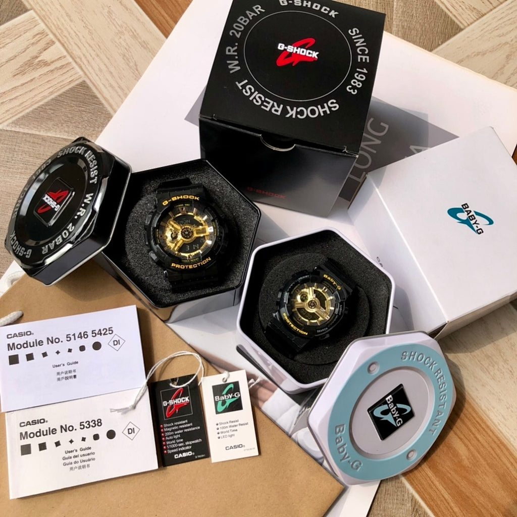 Casio G-Shock and Baby-G watch set with black straps, gold dials, and paperwork.