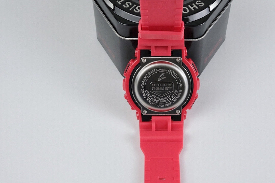 Red G-Shock wristwatch caseback with markings, with red strap