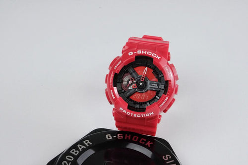Red G-Shock wristwatch with black dial, angled view