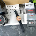 Casio G-Shock watch with black strap and rose-gold case, angled front view