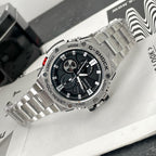 Casio G-Shock wristwatch with steel bracelet and red accent on the crown