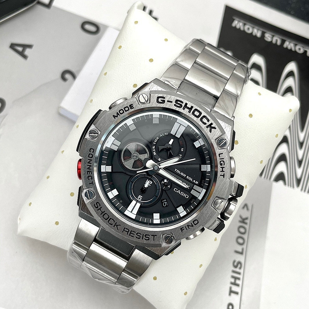 Casio G-Shock wristwatch on white cushion, black dial and stainless steel bracelet