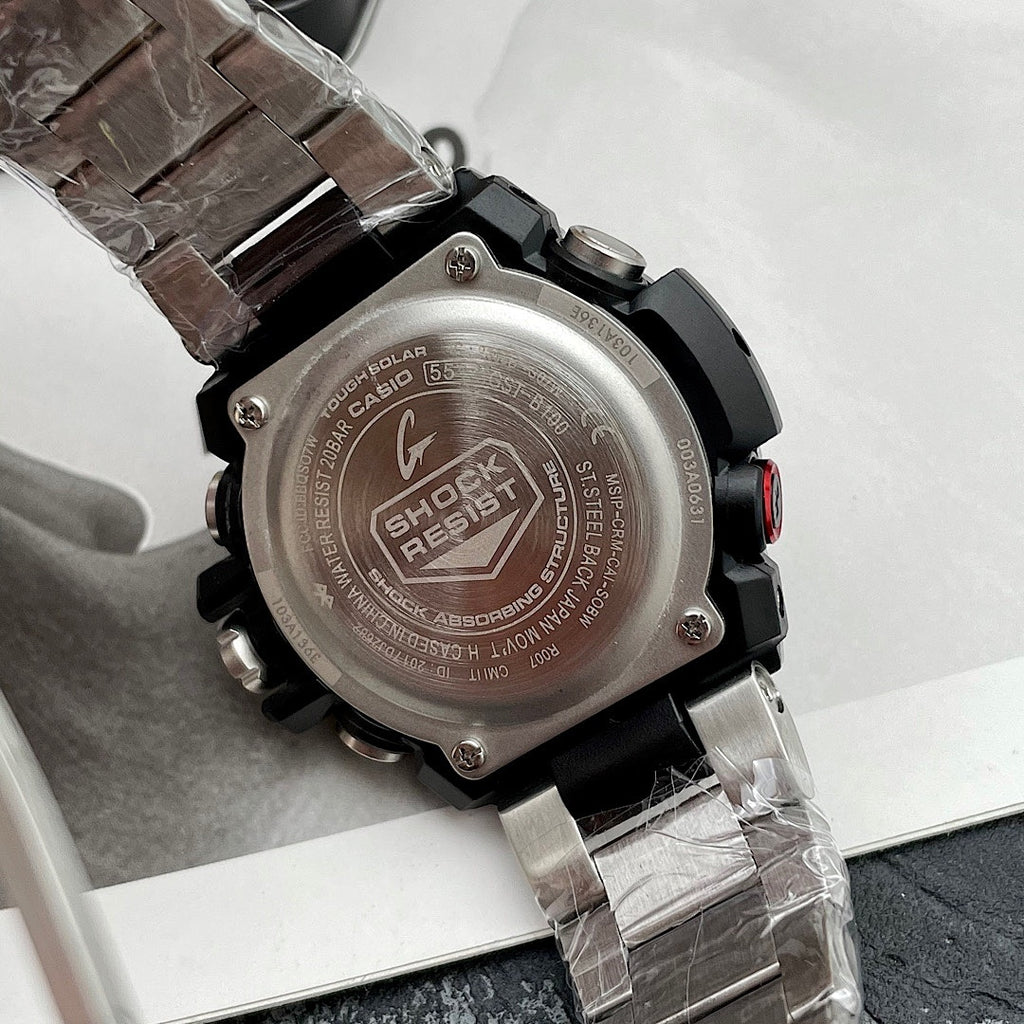 Casio G-Shock wristwatch case back close-up, stainless steel and black rubber strap