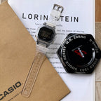 Casio watch with clear strap and black digital face, shown with branded packaging