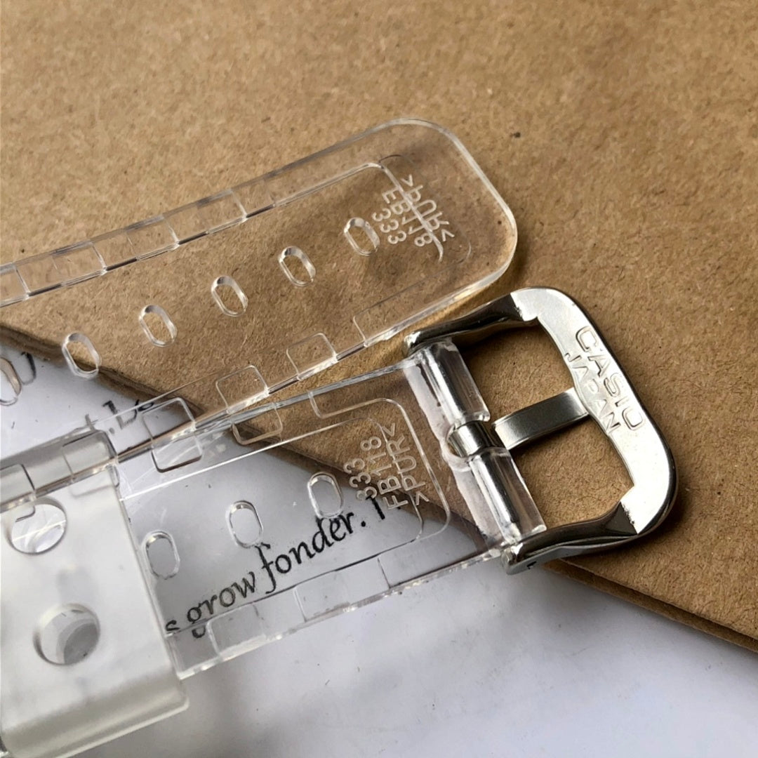 Casio watch clasp and clear resin strap details, silver buckle and black module
