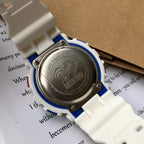 Casio G-Shock case back close-up with engraved metal plate and blue trim