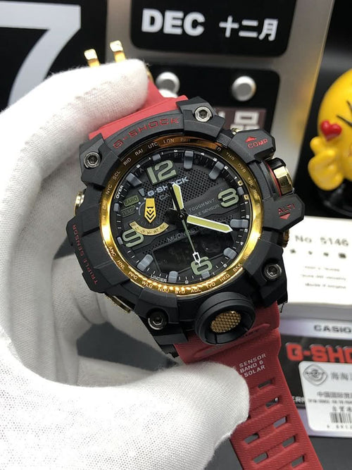 Casio sports watch with black case, red strap, gold bezel accents, round dial detail