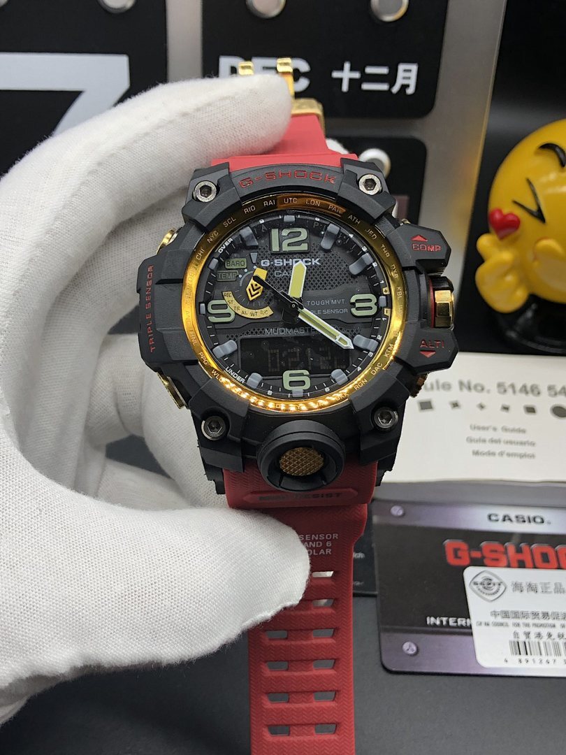 Casio sports watch front view with black case, red band, gold ring around bezel
