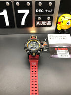 Casio sports watch with red strap and black case, gold bezel accents, full front view