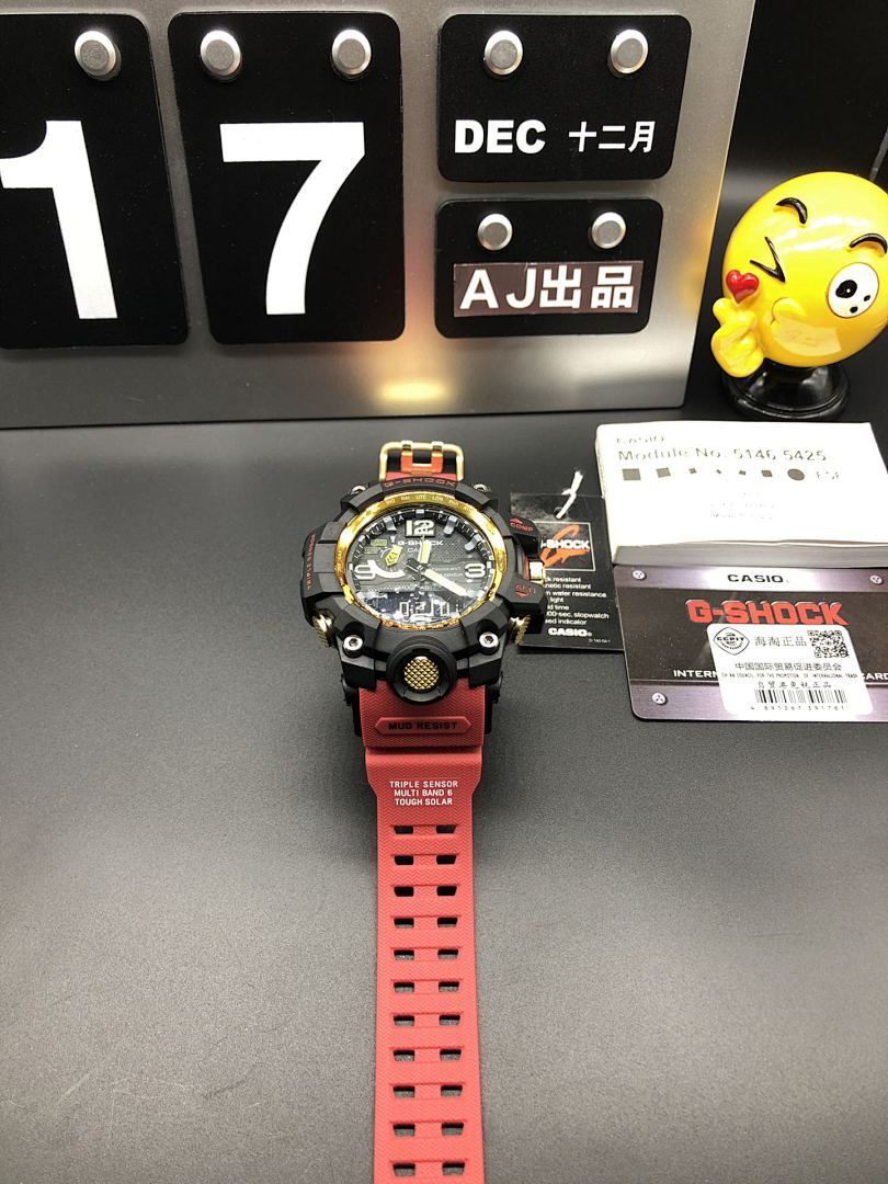 Casio sports watch with red strap and black case, gold bezel accents, full front view