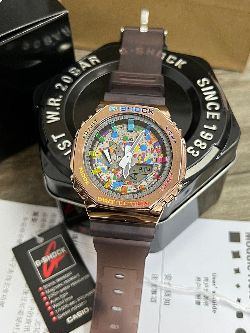 G-Shock watch with brown resin strap and gold-toned case, colorful dial with digital readout