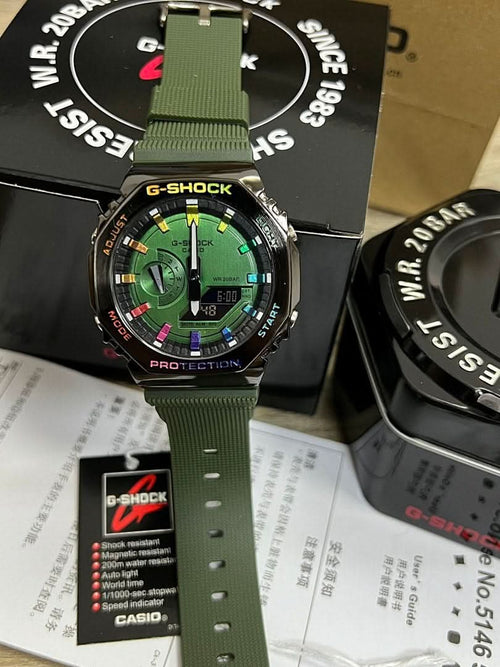 G-Shock watch with green resin strap and round black bezel, green dial with red accents