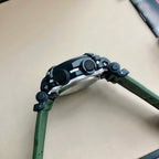Casio G-Shock wristwatch on green resin band with black bezel and round buttons