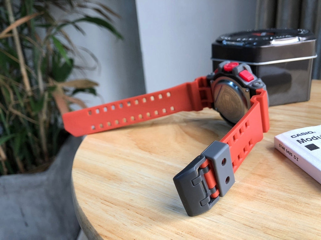 Casio watch with red strap and gray clasp, black bezel