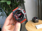Casio watch held in hand with black dial, red highlights, and gray protective bezel