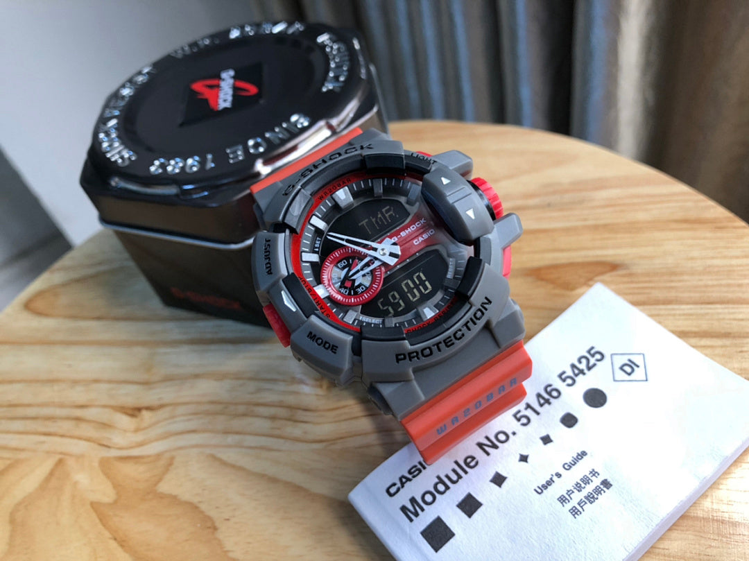 Casio watch angled with black dial, red accents, gray bezel and red strap
