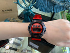 Casio G-Shock watch on wrist with black case and red resin strap, red LCD