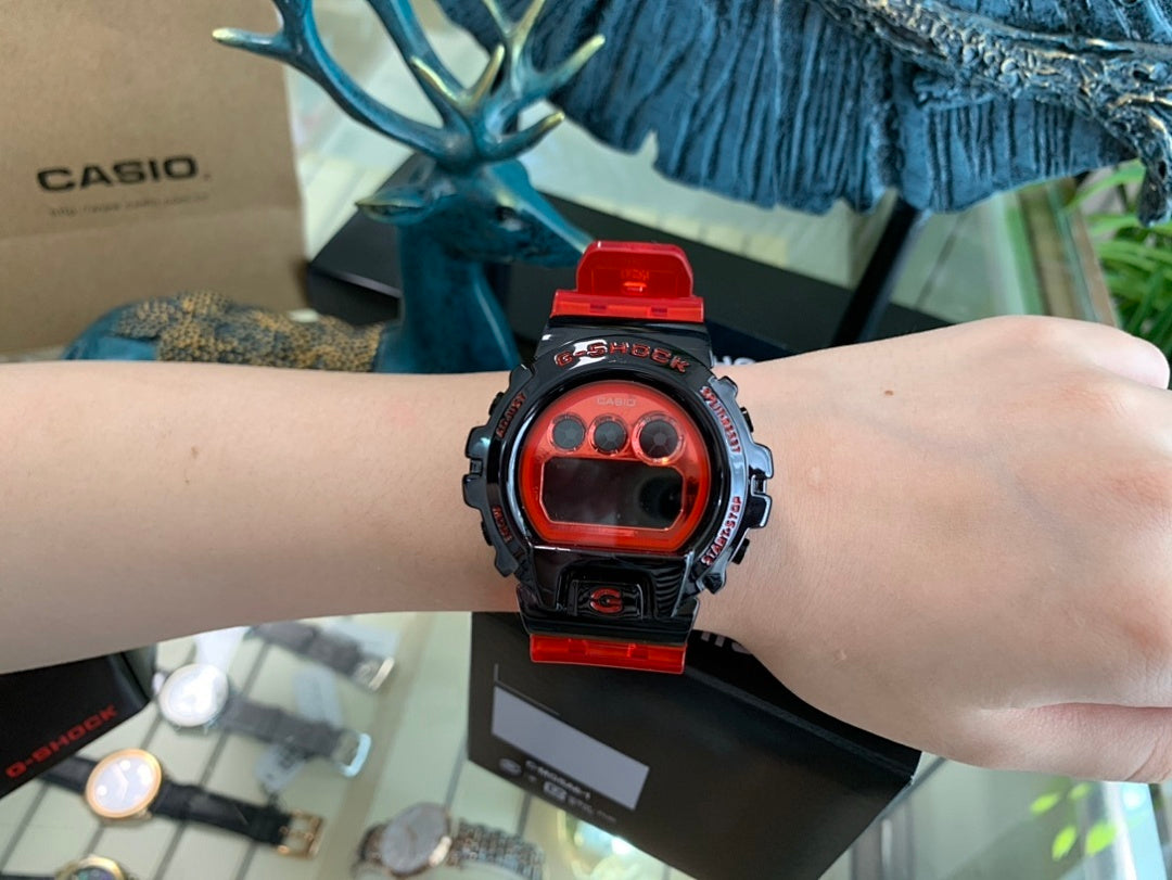 Casio G-Shock watch on wrist with black case and red resin strap, red LCD
