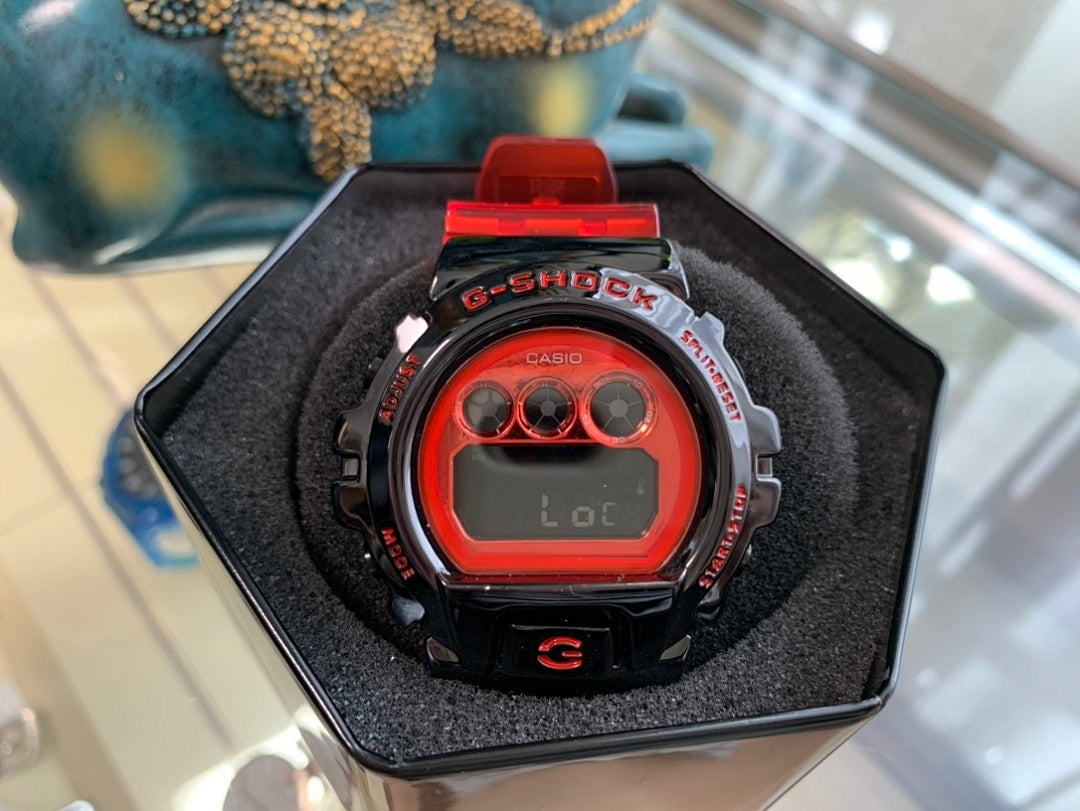 Casio G-Shock watch in black display box, black case with red accents