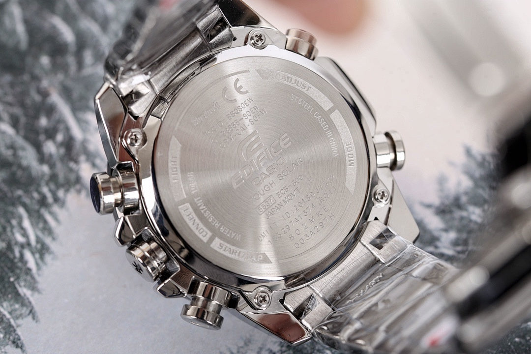 Casio watch back case in silver with engraved markings, on metal bracelet