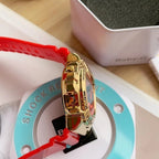 Casio watch with red resin strap, gold-tone bezel and side button details