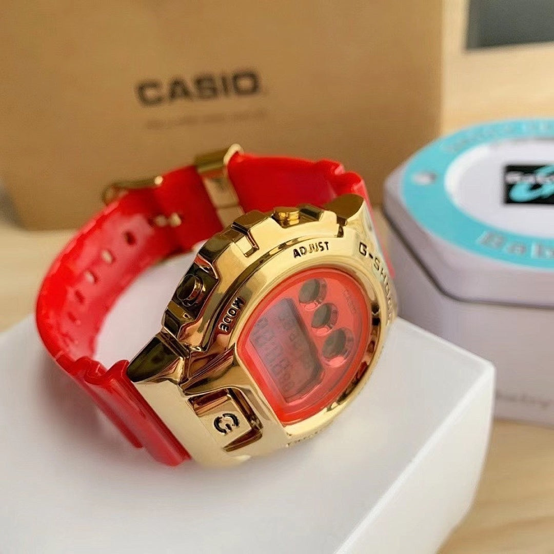 Casio watch with red resin strap and gold-tone case, red digital display