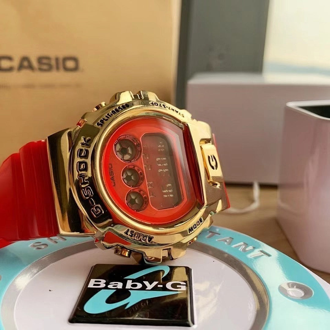 Casio watch with red resin strap and gold-tone case, red digital display close-up