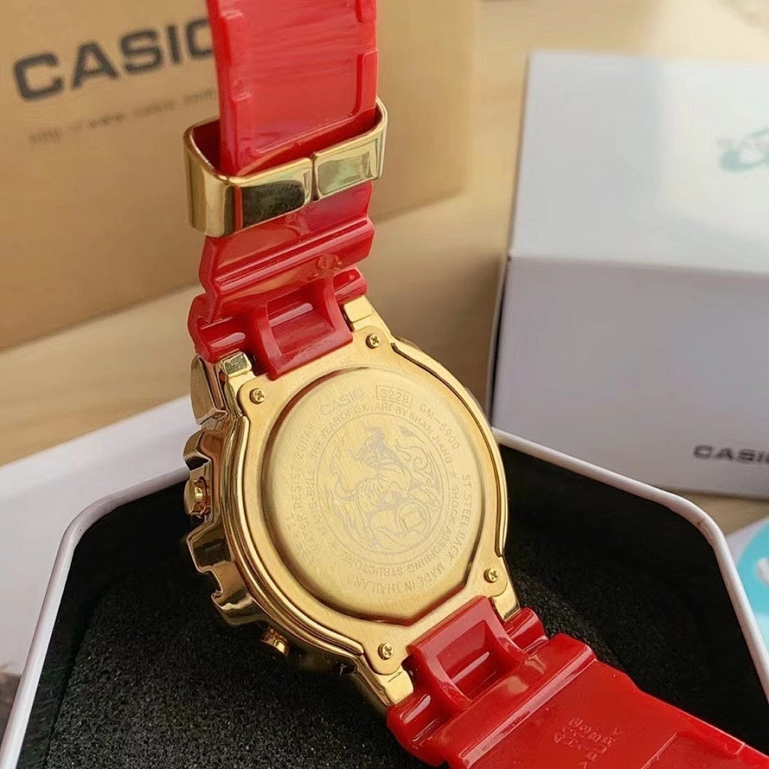 Casio watch with gold-tone case back and red resin strap