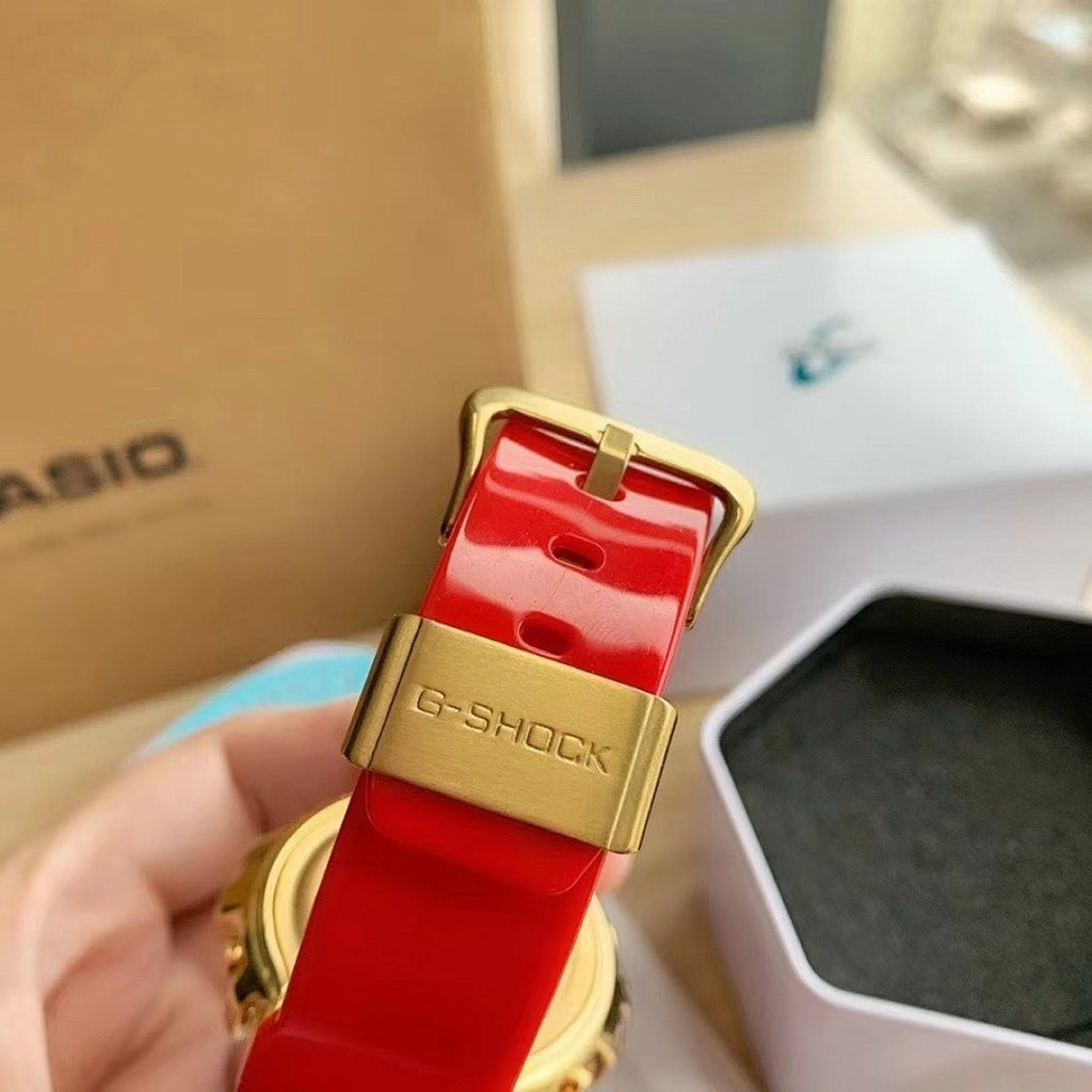 Casio watch with red resin strap and gold-tone buckle and side hardware