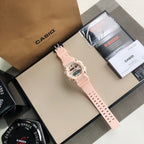 Casio G-Shock digital watch with light pink resin strap, full length side view