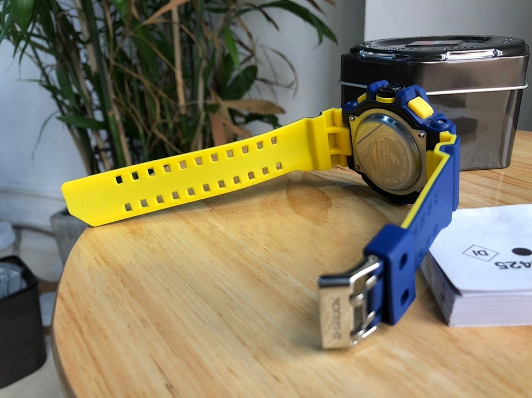 Casio G-Shock watch with yellow strap and blue clasp, silver case back