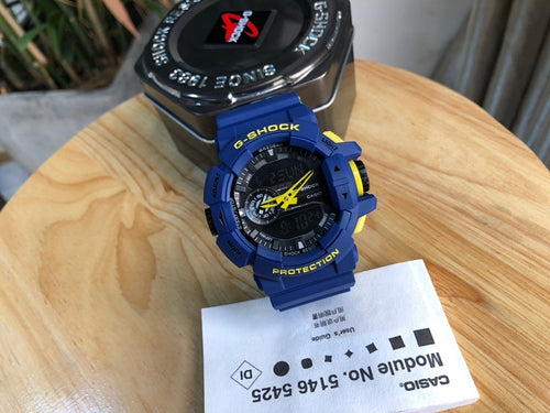 Casio G-Shock blue digital watch with yellow hands and black dial bezel