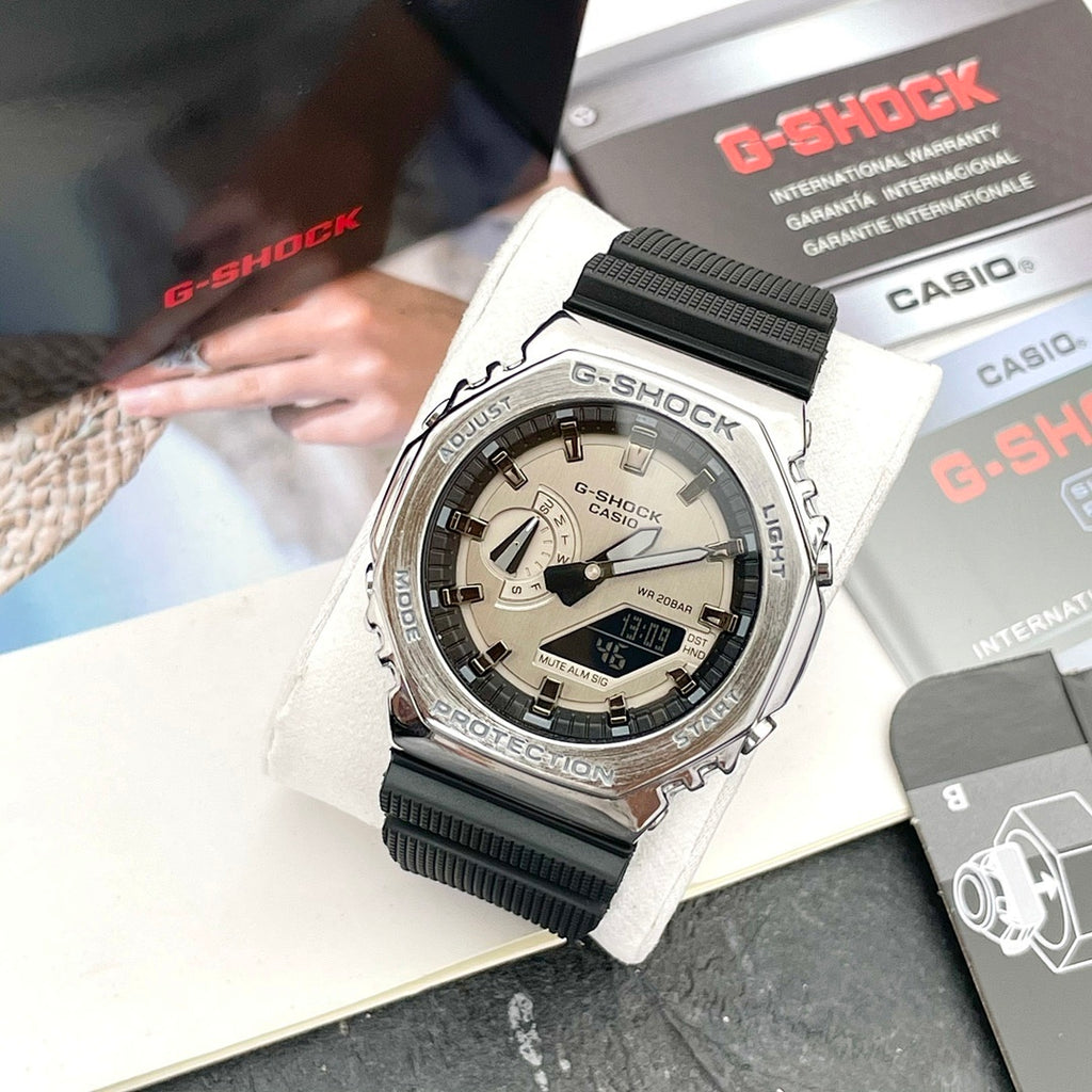 Casio G-Shock watch on wrist with black resin strap and light dial, silver bezel