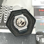 Casio G-Shock watch with black resin strap and silver bezel, light dial