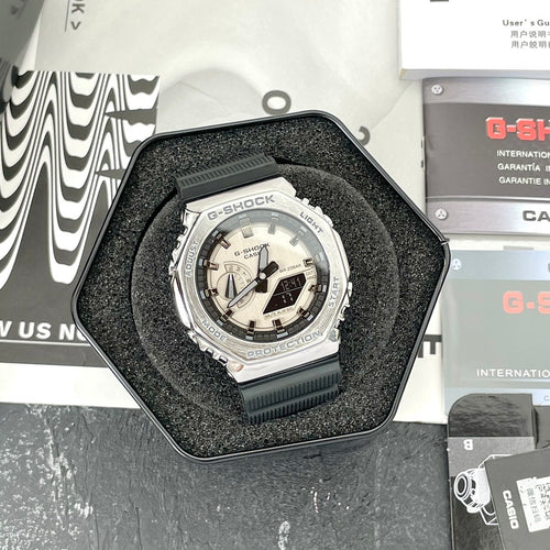 Casio G-Shock watch with black resin strap and silver bezel, light dial