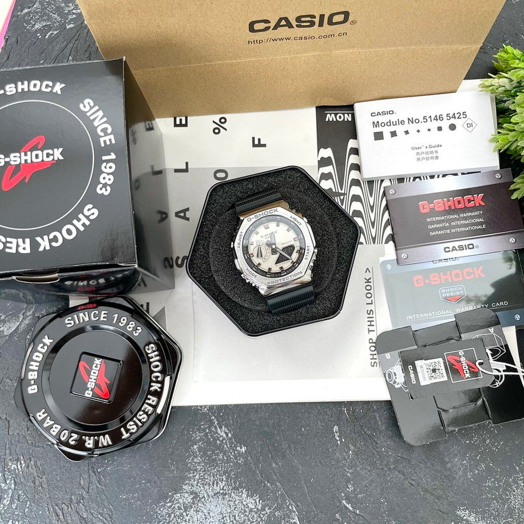 Casio G-Shock watch in display case with black strap and light dial