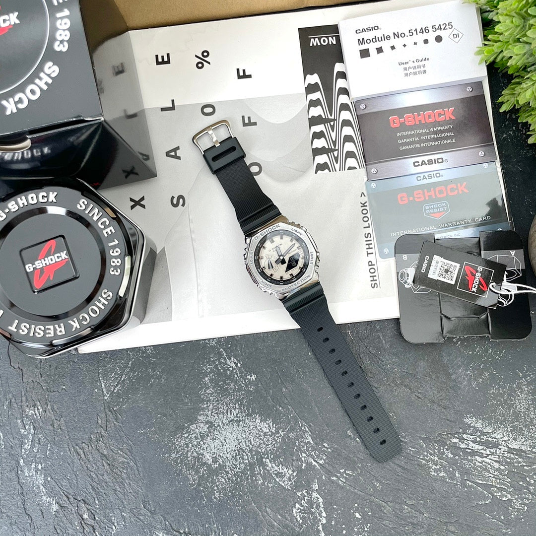 Casio G-Shock watch with black resin strap and silver bezel, light dial