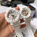 Casio watches with white resin straps and gold-toned multi-dial faces held in hand