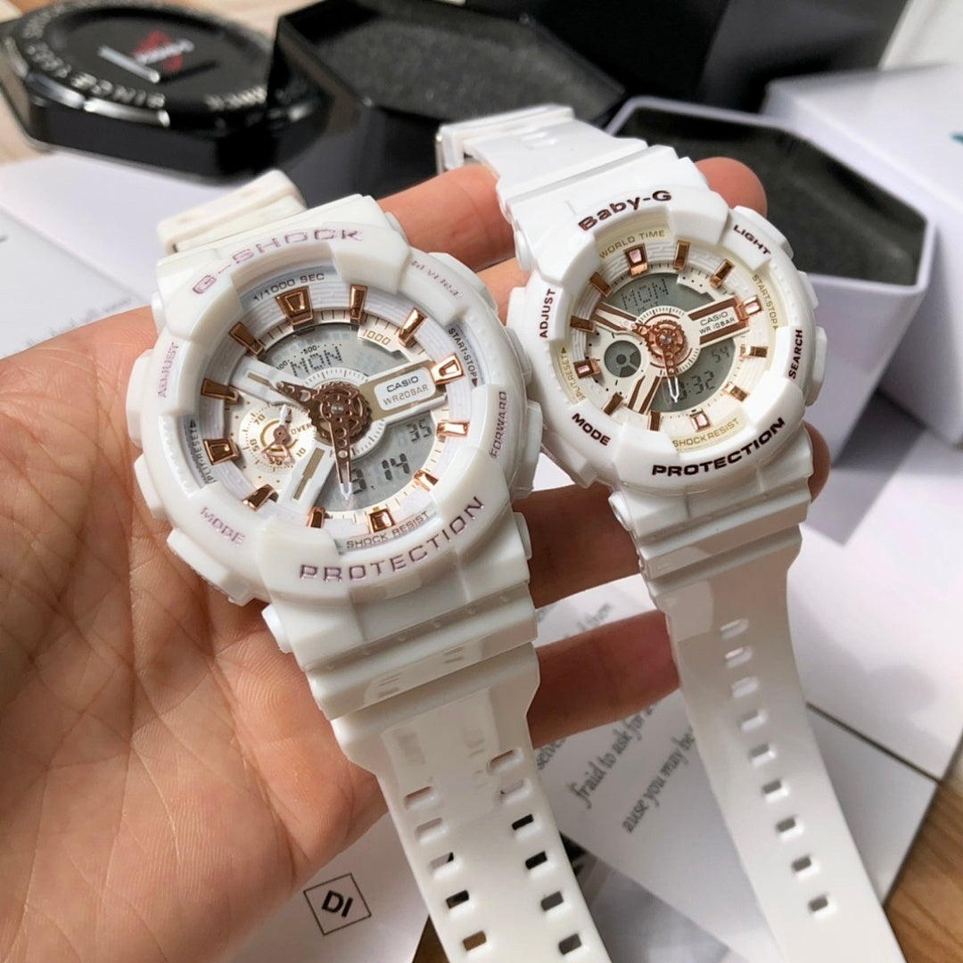 Casio watches with white resin straps and gold-toned multi-dial faces held in hand