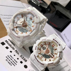 Casio watch pair with white resin straps and gold-toned multi-dial faces, boxed